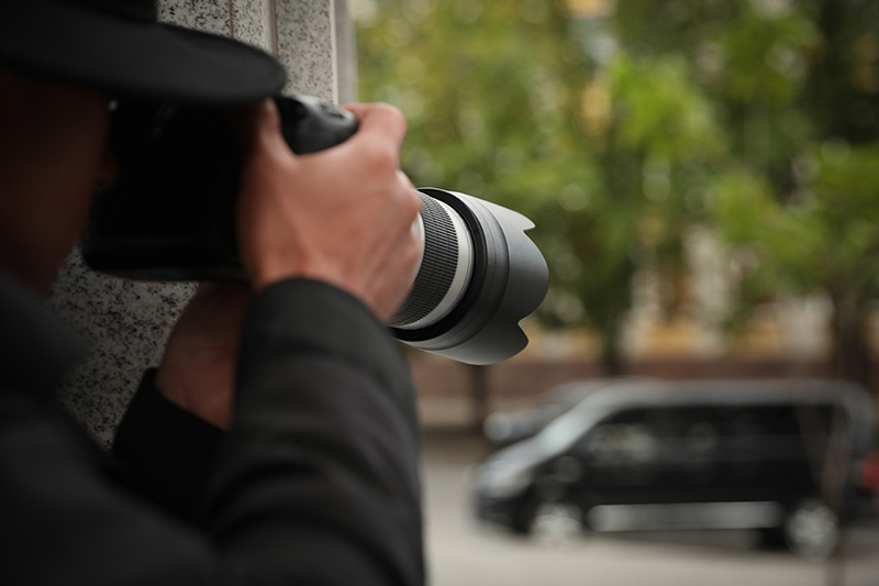 investigator using a camera for surveillence.